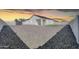 Large backyard offers ample space with gravel landscaping, potential for customization at 14178 S Diablo Rd, Arizona City, AZ 85123