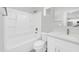 Clean bathroom with a white vanity, bath tub, and a view of the kitchen at 14178 S Diablo Rd, Arizona City, AZ 85123