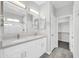 Bathroom featuring double sinks, large mirrors, and a doorway leading into the closet at 14178 S Diablo Rd, Arizona City, AZ 85123