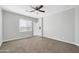 Neutral bedroom with carpet, ceiling fan, and a bright window with blinds at 14178 S Diablo Rd, Arizona City, AZ 85123
