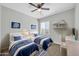 Neutral bedroom featuring two beds, a ceiling fan, a window and a workspace at 14178 S Diablo Rd, Arizona City, AZ 85123