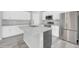 A bright kitchen with white cabinets, an island, stainless steel appliances, and a stylish faucet at 14178 S Diablo Rd, Arizona City, AZ 85123