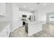 Modern kitchen featuring an island with seating, white cabinetry, stainless steel appliances and an open layout at 14178 S Diablo Rd, Arizona City, AZ 85123