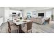 Beautiful open-concept living space with modern dining area and sleek white kitchen at 14178 S Diablo Rd, Arizona City, AZ 85123