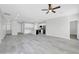 Open-concept living room showcasing neutral paint, modern ceiling fan, and an adjacent kitchen at 14178 S Diablo Rd, Arizona City, AZ 85123