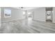 Bright and airy living room features neutral paint, wood floors and sliding glass doors to backyard at 14178 S Diablo Rd, Arizona City, AZ 85123