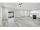 Open-concept living area with sliding glass door to patio and a modern kitchen with white cabinets and island at 14178 S Diablo Rd, Arizona City, AZ 85123