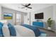 Bright primary bedroom features a ceiling fan, large windows, and stylish decor at 14178 S Diablo Rd, Arizona City, AZ 85123