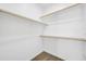 Walk-in closet featuring wooden racks and carpeted floor at 14178 S Diablo Rd, Arizona City, AZ 85123