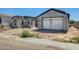 Exterior view of home under construction displaying partial scaffolding, an incomplete roof, and a tan gravel yard at 14687 N 73Rd Dr, Peoria, AZ 85381