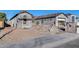 New construction showcasing modern design with gray stucco, tile roof, and scaffolding around arched window at 14687 N 73Rd Dr, Peoria, AZ 85381