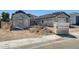 Exterior view of home under construction showing partial scaffolding, cinderblock foundation, and a tan gravel yard at 14687 N 73Rd Dr, Peoria, AZ 85381