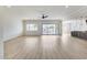 Open concept living room flows into the kitchen with access to outdoor patio at 14687 N 73Rd Dr, Peoria, AZ 85381
