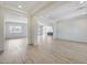 Spacious living room features an open layout, wood-look tile flooring, and natural light at 14687 N 73Rd Dr, Peoria, AZ 85381