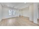 Bright living room with wood-look tile floors, white walls, and recessed lighting at 14687 N 73Rd Dr, Peoria, AZ 85381