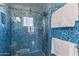 Modern bathroom featuring stylish blue tiling in the walk-in shower with a glass enclosure at 15221 N Clubgate Dr # 2059, Scottsdale, AZ 85254