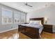 Comfortable bedroom featuring a ceiling fan, shuttered windows, and hardwood floors at 15221 N Clubgate Dr # 2059, Scottsdale, AZ 85254