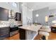 Spacious kitchen with a breakfast bar island, stainless steel range hood, and modern fixtures at 15221 N Clubgate Dr # 2059, Scottsdale, AZ 85254