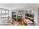 Open-concept living room boasts a fireplace, wet bar, and stainless appliances in the kitchen at 15221 N Clubgate Dr # 2059, Scottsdale, AZ 85254