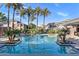 Resort-style pool area surrounded by palm trees and well-maintained landscaping offers a luxurious outdoor experience at 15221 N Clubgate Dr # 2059, Scottsdale, AZ 85254