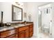 Well-lit bathroom with granite countertops, natural wood vanity, and a separate toilet and shower area at 15816 E Eagle Crest Rd, Fountain Hills, AZ 85268