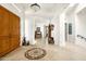 Grand foyer featuring a decorative tile inlay, arched doorways, and rich wood accents at 15816 E Eagle Crest Rd, Fountain Hills, AZ 85268
