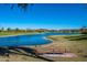 Scenic view of a lake from a bench, surrounded by lush greenery and waterfront homes at 15816 E Eagle Crest Rd, Fountain Hills, AZ 85268