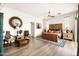 Bright main bedroom with wood floors, ceiling fan, sitting area, and large wooden headboard at 15816 E Eagle Crest Rd, Fountain Hills, AZ 85268