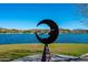 Unique moon sculpture overlooks a serene lake and residential area at 15816 E Eagle Crest Rd, Fountain Hills, AZ 85268