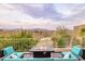 Enjoy the tranquil desert sunset from this patio featuring cozy seating and a modern gas fire pit at 15816 E Eagle Crest Rd, Fountain Hills, AZ 85268