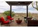 A shaded pergola offers an outdoor living space with comfortable seating and scenic views of the surrounding landscape at 15816 E Eagle Crest Rd, Fountain Hills, AZ 85268