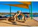 Outdoor playground with colorful slides, climbing equipment, and a shaded area by the lake at 15816 E Eagle Crest Rd, Fountain Hills, AZ 85268
