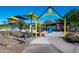 Brightly colored playground with slides, climbing structures, and shade canopies by a lake at 15816 E Eagle Crest Rd, Fountain Hills, AZ 85268