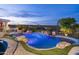 A unique backyard pool surrounded by rockwork and professional landscaping offers a relaxing getaway at 15816 E Eagle Crest Rd, Fountain Hills, AZ 85268