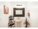 Classic powder room with pedestal sink, decorative mirror, and colorful art at 15816 E Eagle Crest Rd, Fountain Hills, AZ 85268