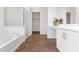 Bright bathroom featuring a soaking tub, separate shower, and white vanity with stylish decor at 15959 W Hearn Rd, Surprise, AZ 85379