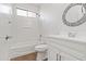 This bathroom features a shower-tub combo, and vanity sink with a decorative mirror at 15959 W Hearn Rd, Surprise, AZ 85379