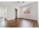 A bright bedroom with hardwood floors, a closet, and a sunlit window at 15959 W Hearn Rd, Surprise, AZ 85379