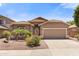 Single-story home featuring a well-maintained yard, desert landscaping and attached two-car garage at 15959 W Hearn Rd, Surprise, AZ 85379