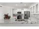 Modern kitchen featuring sleek stainless steel appliances, marble countertops, and stylish backsplash at 15959 W Hearn Rd, Surprise, AZ 85379