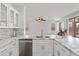 Modern kitchen features marble countertop, a stainless steel dishwasher, and plenty of storage space at 15959 W Hearn Rd, Surprise, AZ 85379