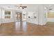 Open concept living area showcasing tile flooring, bright natural light, and seamless flow to the kitchen at 15959 W Hearn Rd, Surprise, AZ 85379