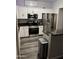 Well-lit kitchen featuring stainless steel appliances, white cabinetry, and granite countertops at 1601 N Saba St # 255, Chandler, AZ 85225