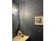 Chic powder room with geometric wallpaper, elegant fixtures, and a modern vanity, perfect for guests at 1601 N Saba St # 255, Chandler, AZ 85225