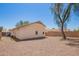 Backyard featuring desert landscaping, stucco, a block wall, and a mature shade tree at 1608 S 82Nd Dr, Phoenix, AZ 85043