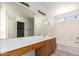 Clean bathroom featuring a large mirror, single vanity, and a shower-tub combo at 1608 S 82Nd Dr, Phoenix, AZ 85043