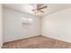Light-filled bedroom with carpet flooring and a window for natural light at 1608 S 82Nd Dr, Phoenix, AZ 85043