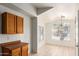 Bright dining area featuring large windows and tiled floors, next to storage cabinets at 1608 S 82Nd Dr, Phoenix, AZ 85043
