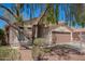 Attractive single-story home with desert landscaping and a two-car garage, shaded by a tree at 1608 S 82Nd Dr, Phoenix, AZ 85043