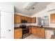 Well-lit kitchen showcasing stainless steel appliances and light wood cabinets at 1608 S 82Nd Dr, Phoenix, AZ 85043